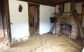 The floors of Blanket Bay resident Gordon Sasse’s back shed are still caked with mud, almost five months after July’s downpour.