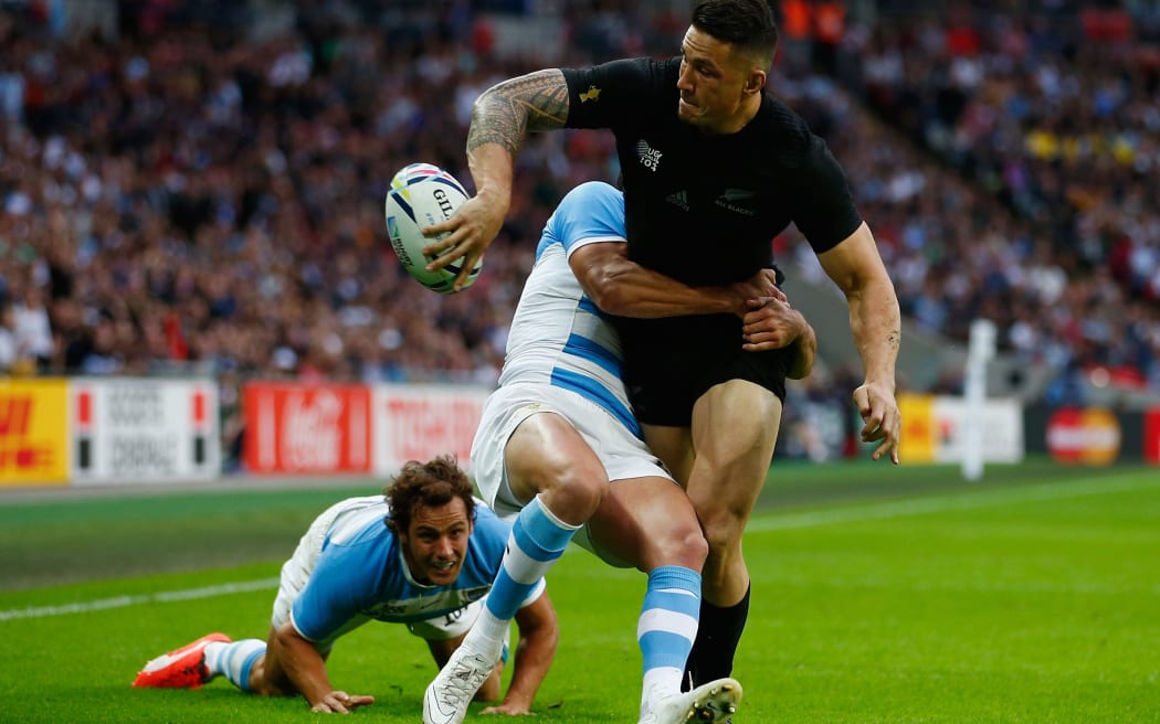 Sonny Bill Williams off-loads in the tackle during the All Blacks' victory over Argentina in the opening round of the 2015 Rugby World Cup.