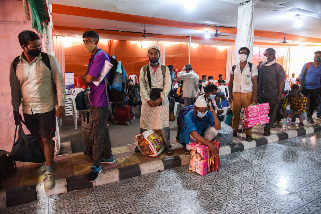 Passengers arrive at Guwahati Railway station and wait in queue to test for COVID-19 coronavirus.