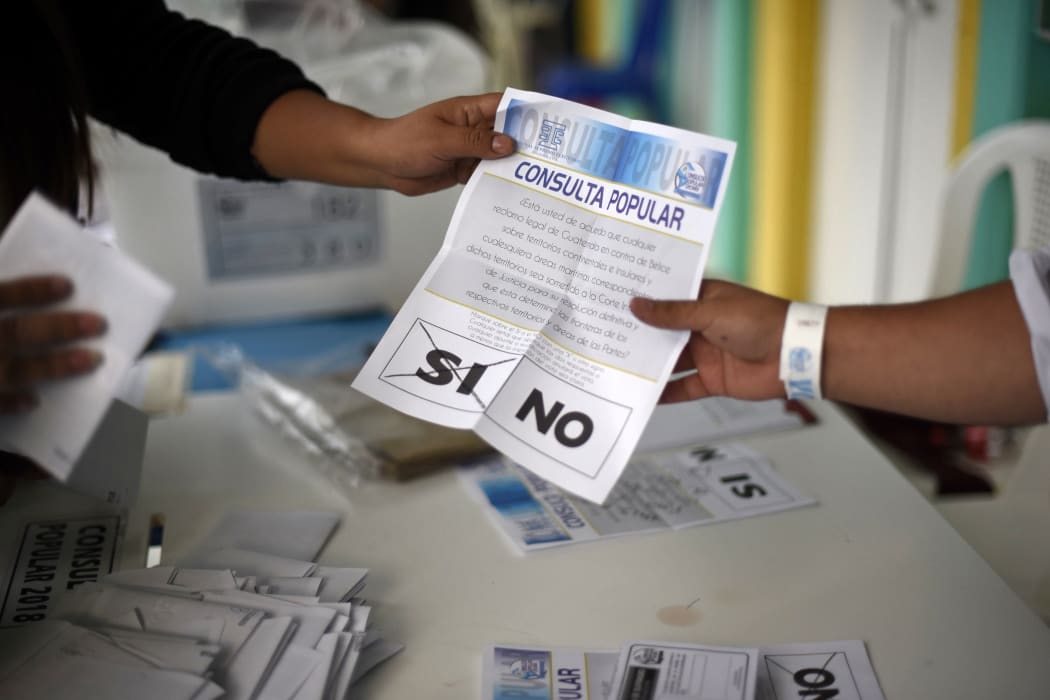 Members of the Supreme Electoral Court start counting votes at a polling station in Guatemala City, during a referendum on a border dispute with Belize, on April 15, 2018.