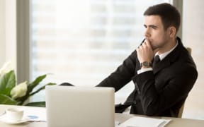 84439981 - thoughtful pensive businessman deep in thoughts looking away sitting near laptop at workplace, successful entrepreneur thinking over new ways to improve business, future perspectives, managing risks