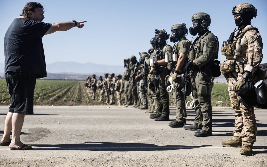 CAMARILLO, CALIFORNIA - JULY 10: Federal agents block people protesting an ICE immigration raid at a nearby licensed cannabis farm on July 10, 2025 near Camarillo, California. Protestors stood off with federal agents for hours outside the farm in the farmworker community in Ventura County. A Los Angeles federal judge is set to rule Friday on a temporary restraining order which would restrict area immigration enforcement operations.   Mario Tama/Getty Images/AFP (Photo by MARIO TAMA / GETTY IMAGES NORTH AMERICA / Getty Images via AFP)