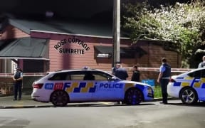 Police outside a dairy in the Auckland suburb of Sandringham where a person was seriously injured after a robbery.