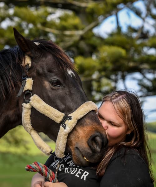 Young woman kisses horse called Sexabeel on the nose at AnnaRehab.