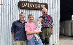 Owen and Emma Harvey, with daughter McKenzie, stand alongside John Harvey, in front of the old woolshed at Daisybank Farm.