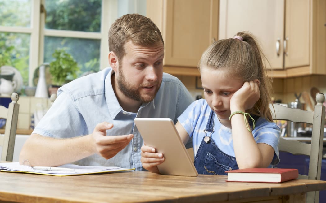 Dad Helping Girl Struggling With Studies