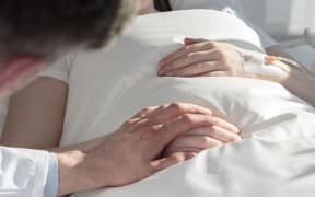 male doctor tends female patient