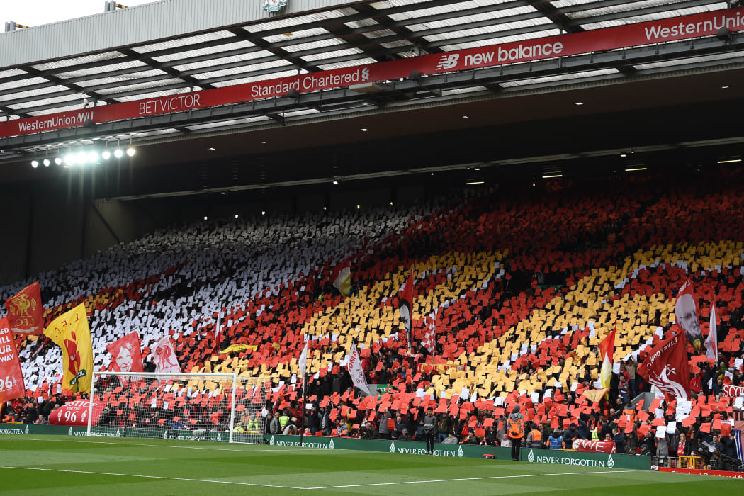 Liverpool's fans hold up a mosaic making out the number "96" as they observe a minute's silence for the 30th Anniversary of the the Hillsborough disaster.