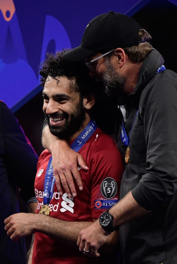 Liverpool's German manager Jurgen Klopp (R) and Liverpool's Egyptian midfielder Mohamed Salah celebrate after winning the UEFA Champions League final football match between Liverpool and Tottenham Hotspur