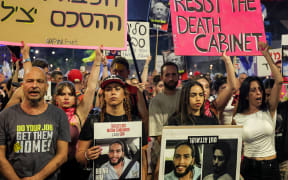 Einav Zangauker (R), mother of Israeli hostage Matan Zangauker, and Matan's girlfriend and former hostage Ilana Gritsevsky (2nd-L) gather with others to attend a demonstration organised by the families of the Israeli hostages taken captive in the Gaza Strip since October 2023 calling for action to secure their release outside the Defence Ministry headquarters in Tel Aviv on 9 August 2025.