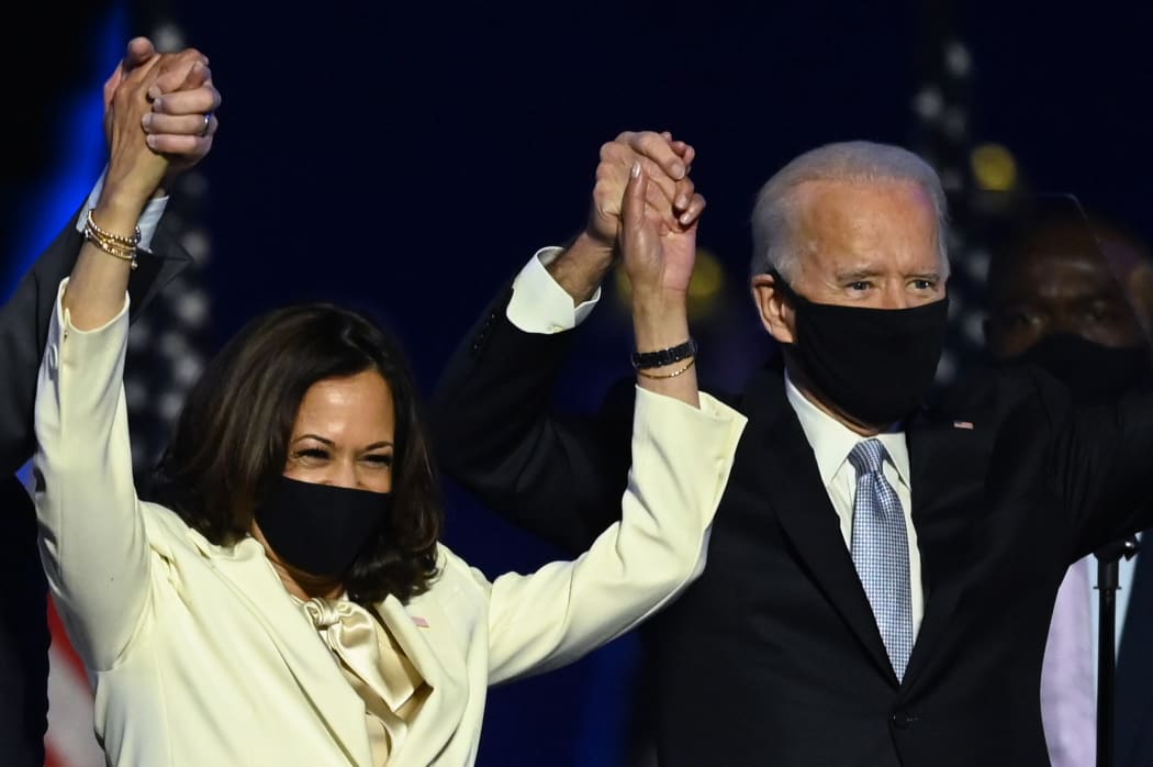 (FILES) In this file photo taken on November 7, 2020 US President-elect Joe Biden and Vice President-elect Kamala Harris stand onstage after delivering remarks in Wilmington, Delaware, after being declared the winners of the presidential election.