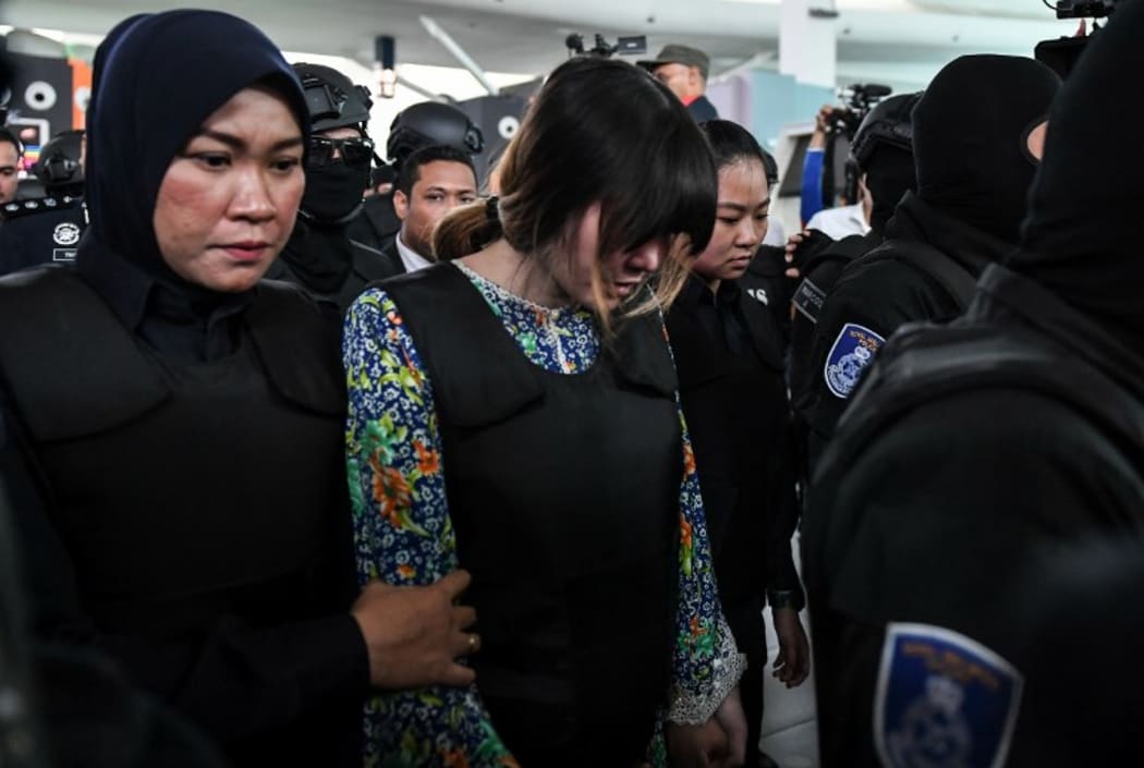 Vietnamese defendant Doan Thi Huong is escorted by police personnel Kuala Lumpur International Airport.