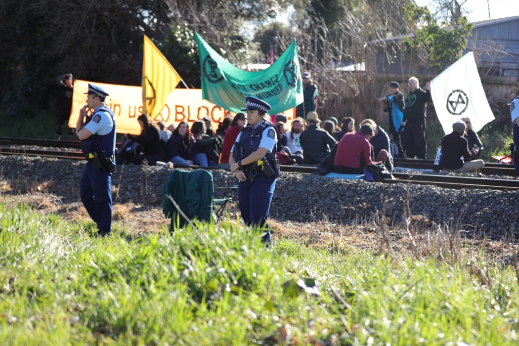 30 Extinction Rebellion members sat on the train tracks in Woolston near Christchurch on 9 August.