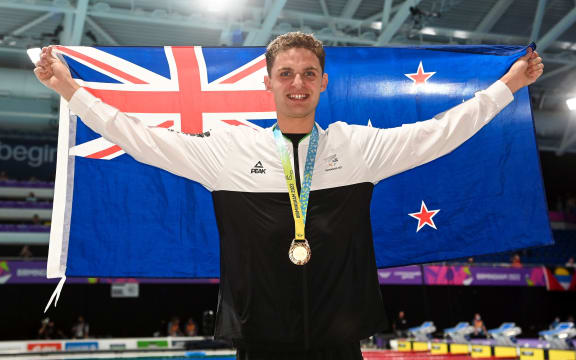 Lewis Clareburt of New Zealand celebrates with his gold medal