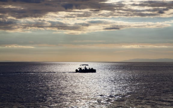 Fishing boat alone in sea.