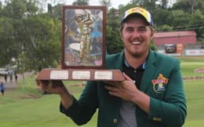 Brad Moules holds aloft the PNG Open trophy.