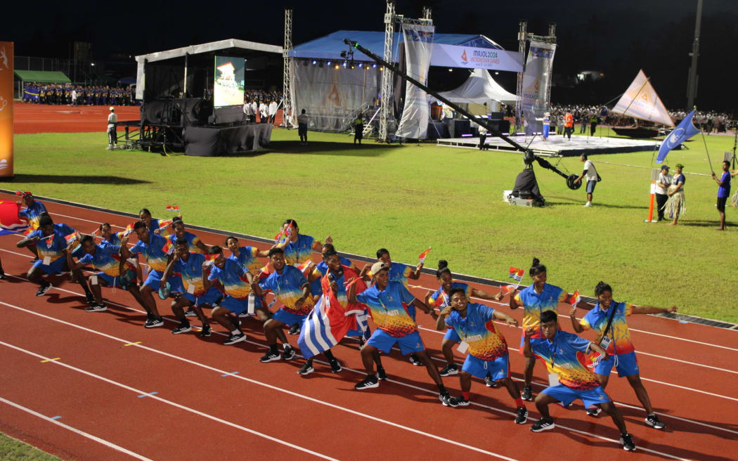 The Kiribati team performs a lively dance as they pass the VIP seating area during the Ten Islands Opening Ceremony Parade of the 10th Micronesian Games in Majuro.
