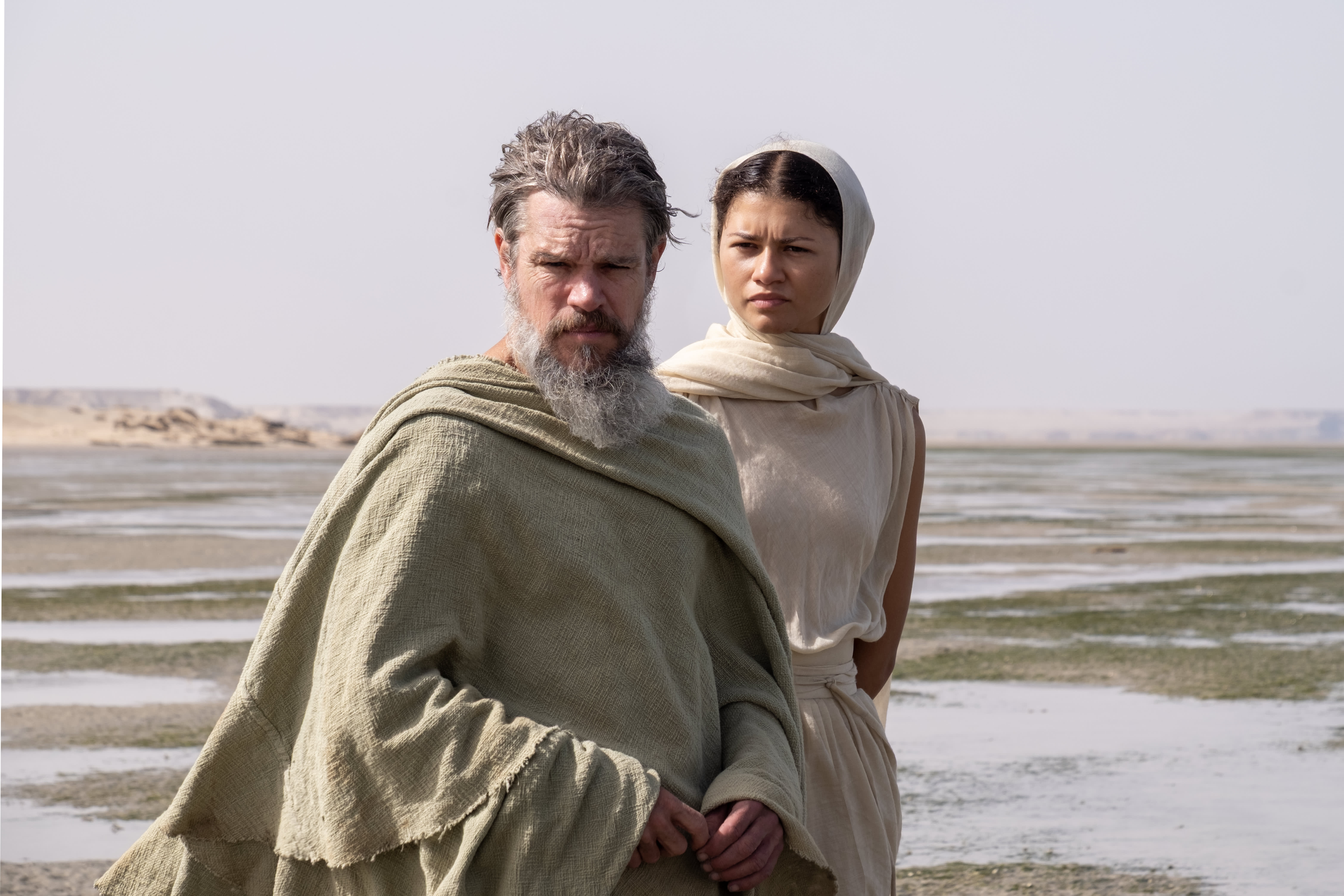 L to R: Matt Damon is Odysseus and Zendaya is Athena in THE ODYSSEY, written, produced, and directed by Christopher Nolan.