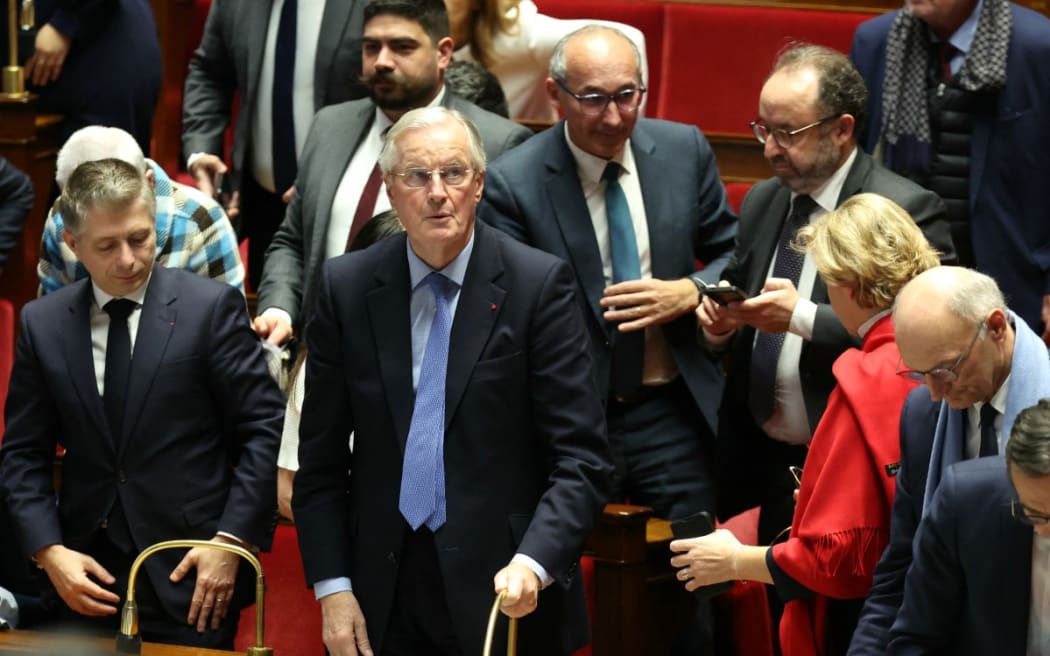 French Prime Minister Michel Barnier reacts after the result of the no-confidence vote on his administration at the National Assembly in Paris on December 4, 2024