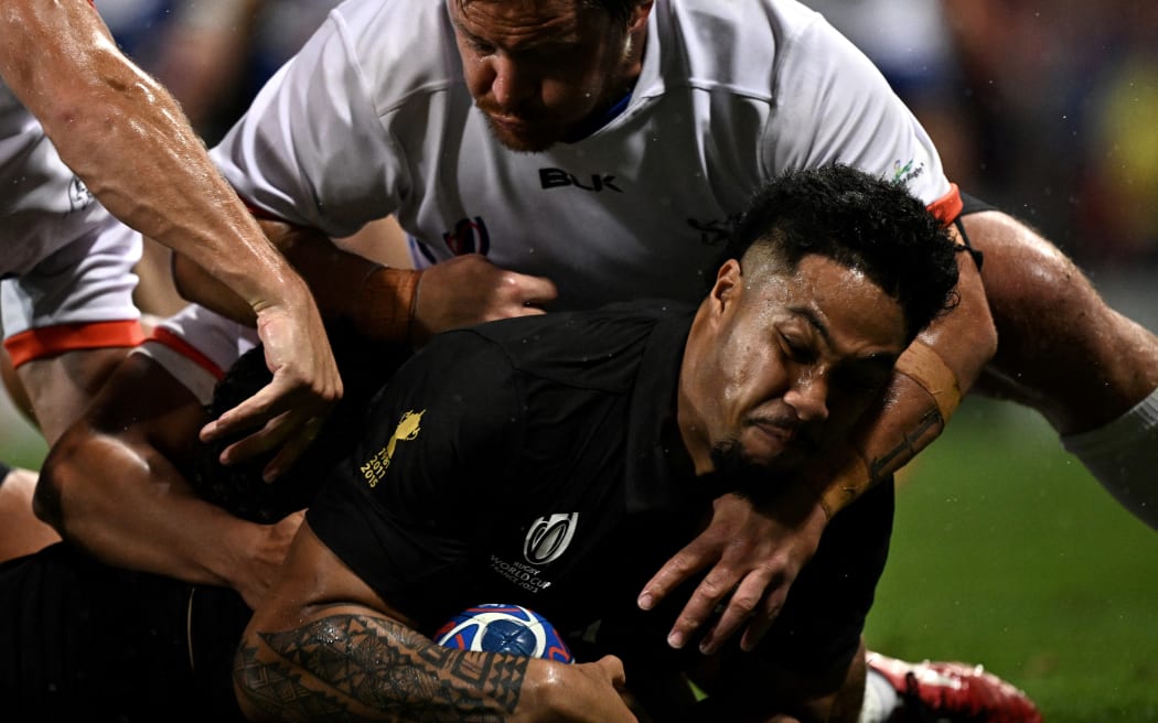 All Black Leicester Fainga'anuku scores a try as Namibian hooker Torsten Van Jaarsveld attempts to tackle him during their Rugby World Cup match.