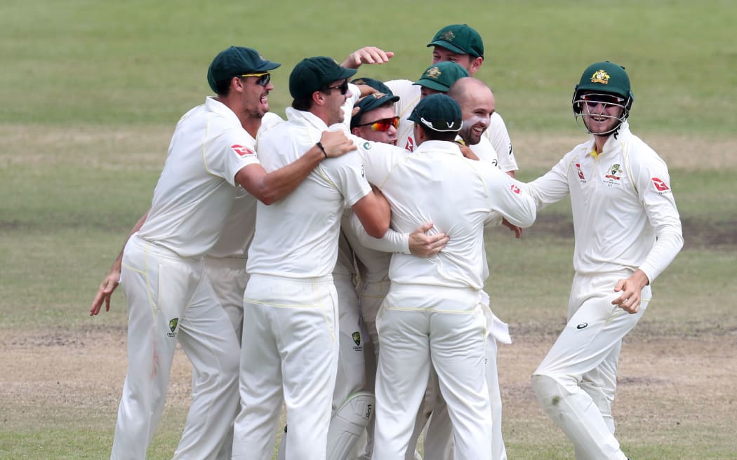 Nathan Michael Lyon of Australia celebrates with teammates after dismissing AB de Villiers of South Africa
