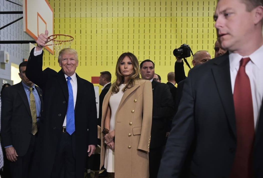 Republican presidential nominee Donald Trump gives the thumbs-up after he and his wife Melania (R) submitted their ballots at a polling station in a school during the 2016 presidential elections on November 8, 2016 in New York.