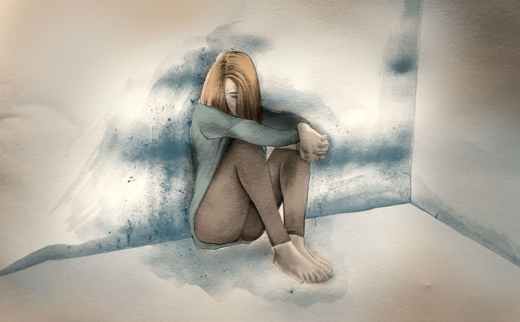 Woman crouched in room feeling depressed.