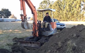 Josh Olykan burying the sheep that were attacked by dogs on his parents' property.