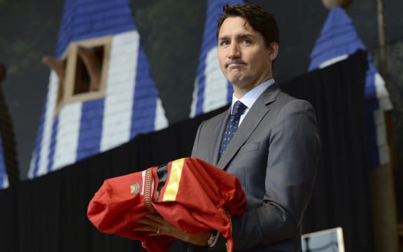 Prime Minister Justin Trudeau stands after being presented with the final report at the closing ceremony for the National Inquiry into Missing and Murdered Indigenous Women and Girls in Gatineau, Quebec., on Monday, June 3, 2019.