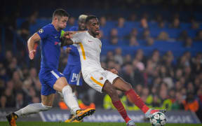 Chelsea defender Gary Cahill and AS Roma's Gerson battle for possession.