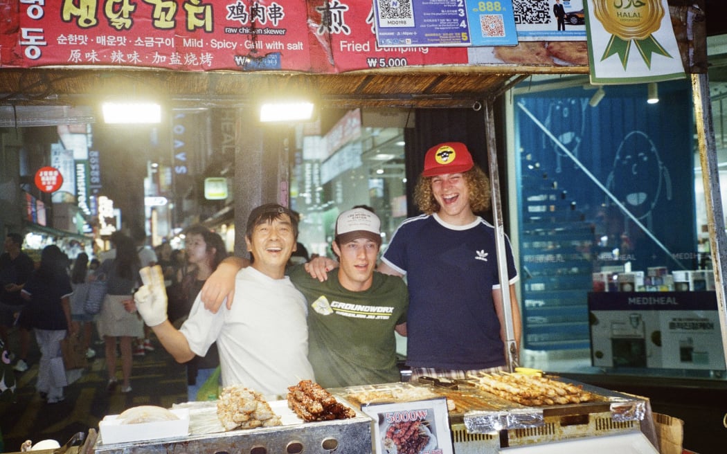 There's a Tuesday band members, Joel Becker (middle) and Gus Murray (right) having fun with the locals in Seoul
