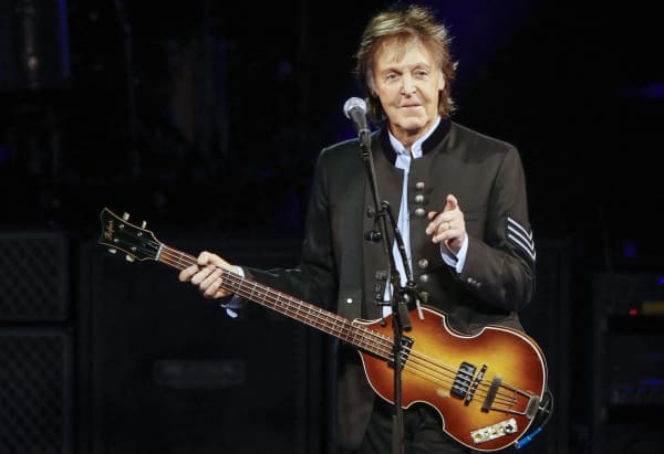(FILES) Sir Paul McCartney performs in concert during his One on One tour at Hollywood Casino Amphitheatre on July 26, 2017 in Tinley Park, Illinois. As revealed by the Financial Times, Universal Music has been asking platforms like Spotify or Apple Music since April to ban access to its catalog to those who want to use it to enrich AI programs. Google and Universal Music are also in talks about possible licenses for AI-generated melodies and artist voices, the Financial Times also reveals. (Photo by Kamil Krzaczynski / AFP)