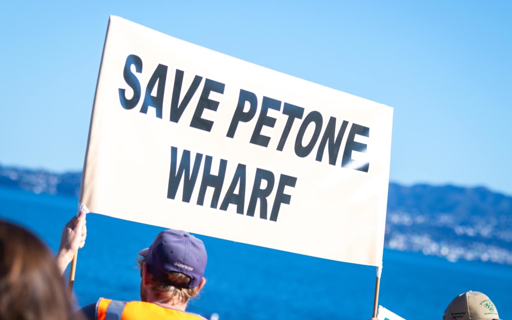 Some of the locals protesting plans to demolish Petone Wharf during a community walk on 28 April 2024.