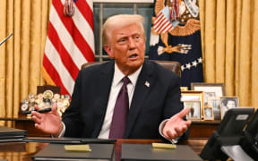 US President Donald Trump speaks to journalists about TikTok as he signs executive orders in the Oval Office of the White House in Washington, DC, on January 20, 2025. (Photo by Jim WATSON / POOL / AFP)