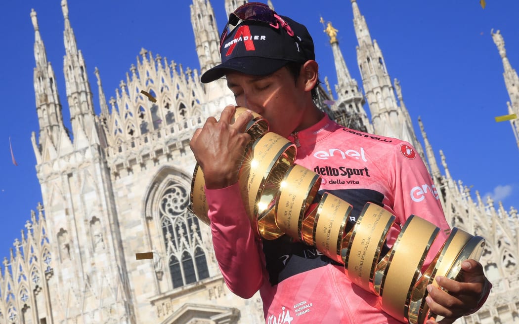 Team Ineos rider Colombia's Egan Bernal kisses the race's Trofeo Senza Fine (Endless Trophy) on the podium after winning the Giro d'Italia 2021 cycling race following the 21st and last stage on May 30, 2021 in Milan.