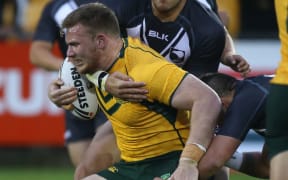 Matt Lodge carries the ball for the Junior Kangaroos against the Junior Kiwis in 2014.
