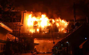 A major fire burns through the Grand Diamond City hotel-casino in Poipet on December 29, 2022.