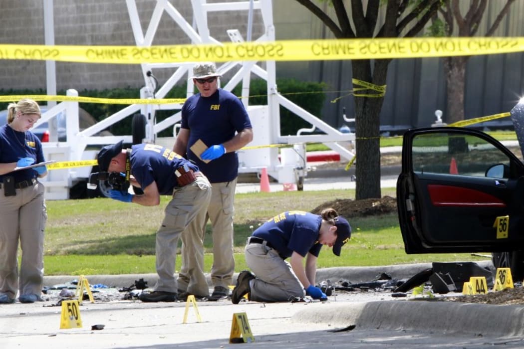 The crime scene before the removal two bodies outside of the Curtis Culwell Center in Garland.