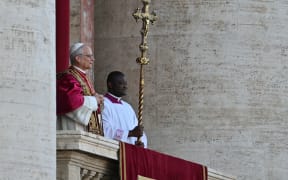 Newly elected Pope Robert Francis Prevost arrives on the main central loggia balcony of the St Peter's Basilica for the first time, after the cardinals ended the conclave, in The Vatican, on May 8, 2025. Robert Francis Prevost was on Thursday elected the first pope from the United States, the Vatican announced. A moderate who was close to Pope Francis and spent years as a missionary in Peru, he becomes the Catholic Church's 267th pontiff, taking the papal name Leo XIV. (Photo by Andrej ISAKOVIC / AFP)