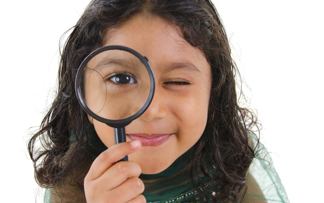 little girl with magnifying glass