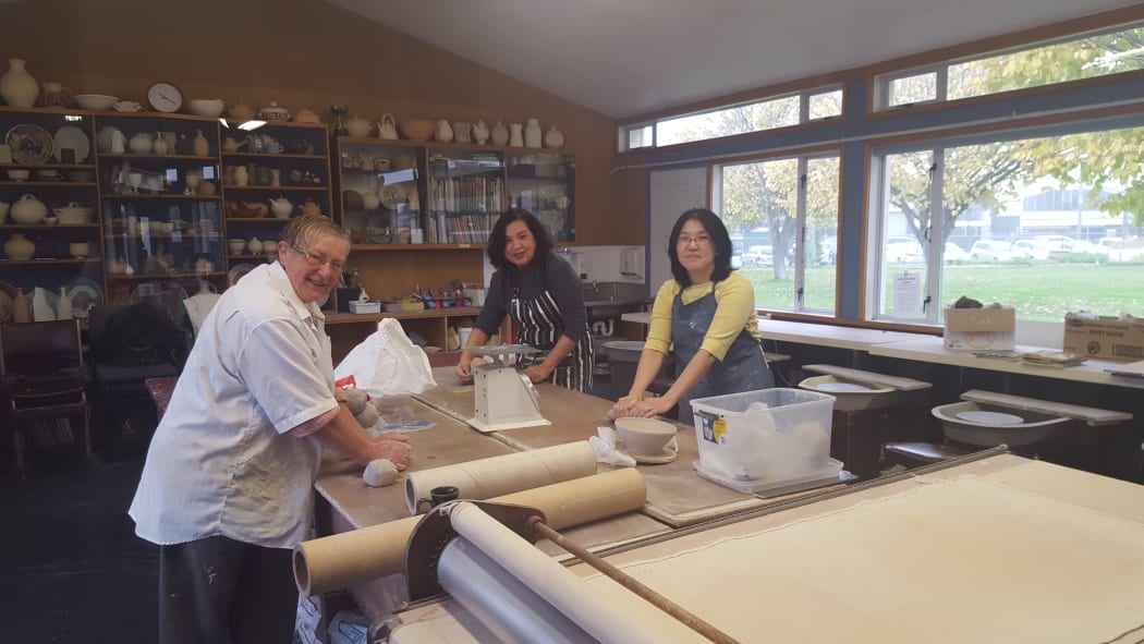 Class tutor Shona Clarkson works with May Li and Catherine Khor at the Mt Pleasant Pottery Group session.