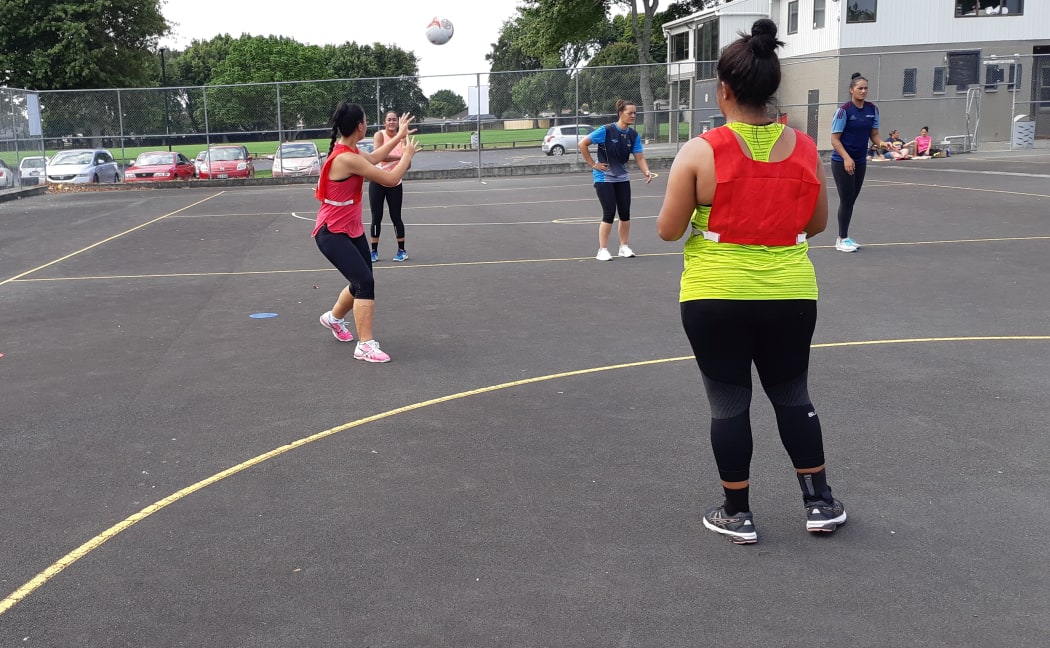Coach Jaqua Heddle (c) watches on during a Tonga training session.