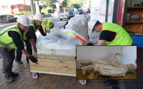 The statue of Robert Scott is moved to the  Canterbury Museum's Quake City exhibition.