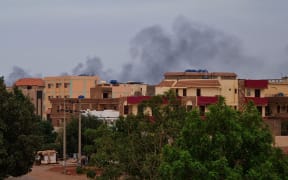 Smoke billows over residential buildings in Khartoum on April 30, 2023 as deadly clashes between rival generals' forces have entered their third week. - Heavy fighting again rocked Sudan's capital as tens of thousands have fled the bloody turmoil and a former prime minister warned of the "nightmare" risk of a descent into full-scale civil war. (Photo by AFP)