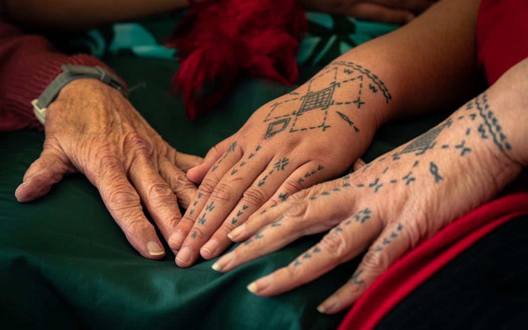 Tusiata Avia displays her hand tatau with her mother and daughter.