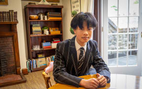 Image of Bill Li sitting at a table.