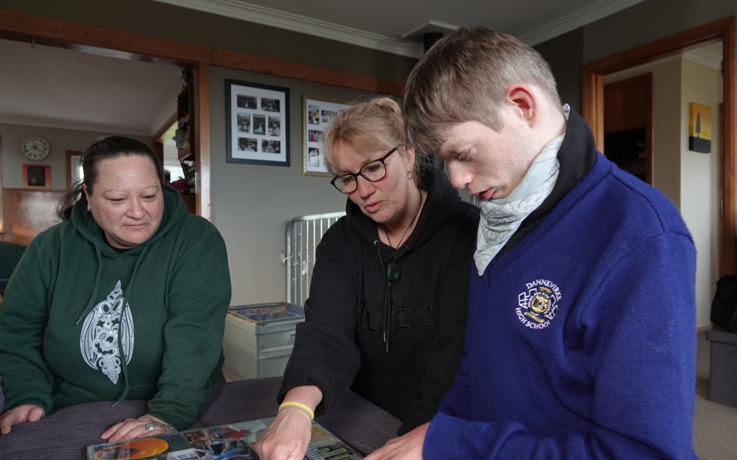 Ryan, with carer Trishna Williams, left, and mum Pip Cook, centre.