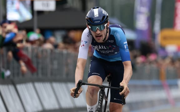 Derek Gee, riding for Israel-Premier Tech, crosses the finish line of the 17th stage of the 108th Giro d'Italia cycling race in Italy, May 28, 2025. (Photo by Luca Bettini / AFP)