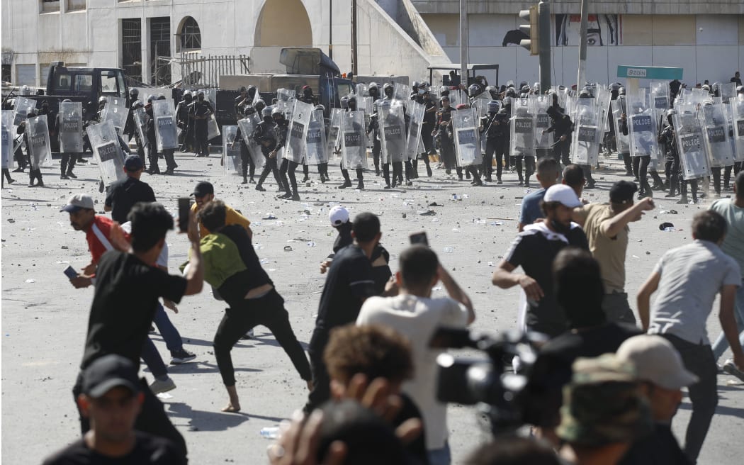 Iraqi supporters of Shiite Muslim cleric Moqtada Sadr clash with security forces in Tahrir Square in the centre of Iraq's capital Baghdad on 28 September, 2022 ahead of a parliament session in the nearby high-security Green Zone across the Tigris river.