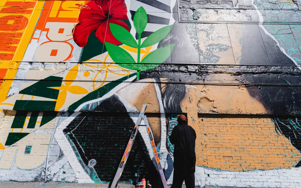A mural created by Christchurch artist Kophie Su’a-Hulsbosch, honouring the legacy of the Dawn Raids and celebrating the resilience of Pacific communities in Aotearoa.